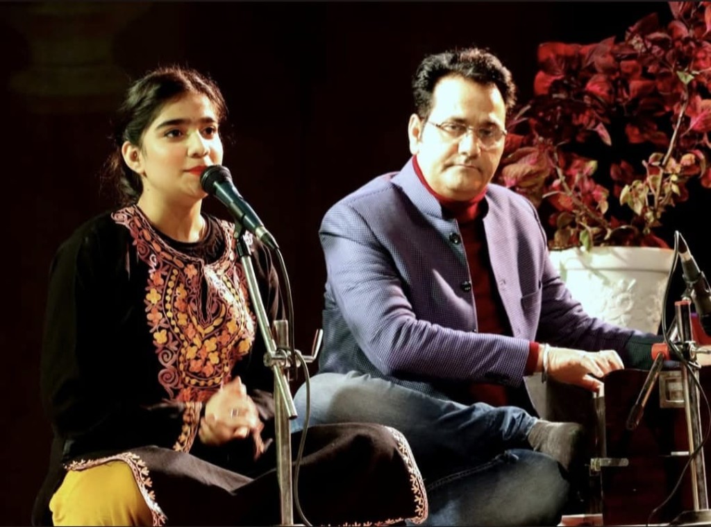 Live duet performance with harmonium on stage